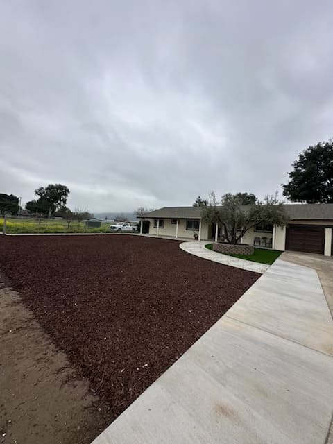 New concrete driveway and mulch landscaping installation in residential property Gilroy California