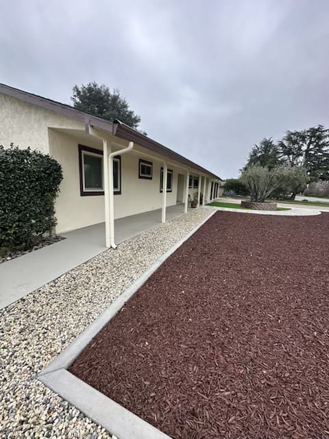 New concrete driveway and mulch landscaping installation in residential property Gilroy California