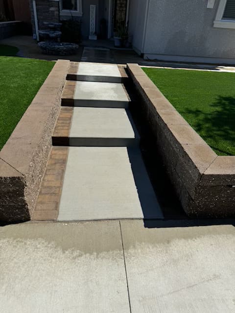 Concrete walkway installation with decorative gravel landscaping in front yard by general contractor in Gilroy, CA