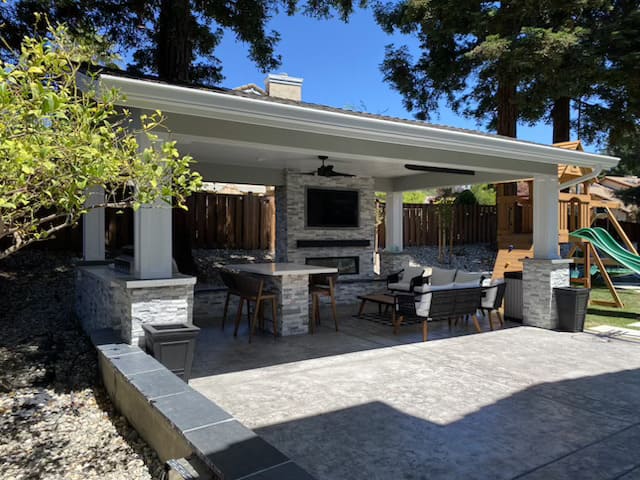 Large backyard landscaping with artificial turf and patio area in California home