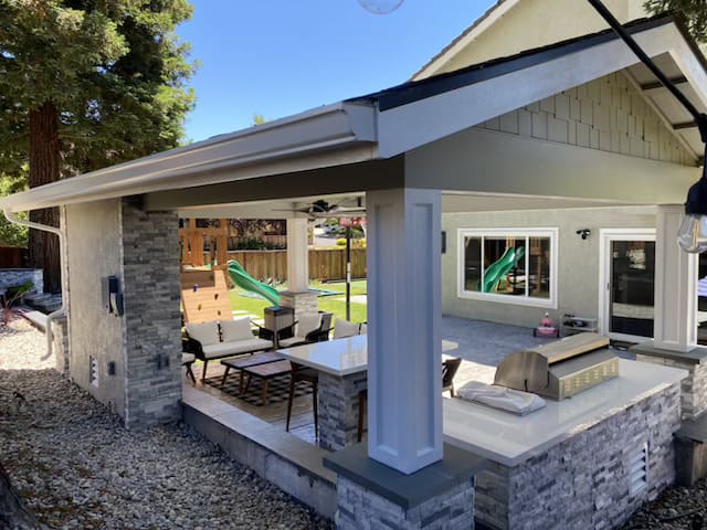 Backyard landscaping with artificial turf and concrete stepping stones in California