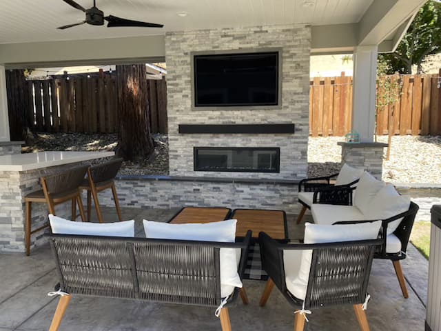 Full home exterior with landscape lighting at night in California residential property