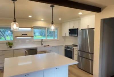 Modern kitchen remodeling with white cabinets, island and open concept design in Gilroy California